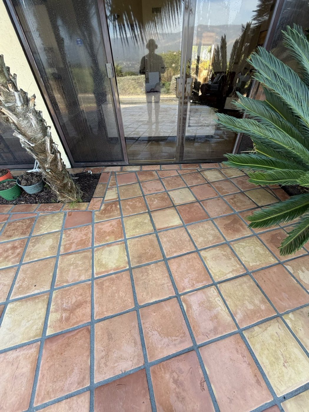 The same patio tile after cleaning, evenly colored right up to the sliding door