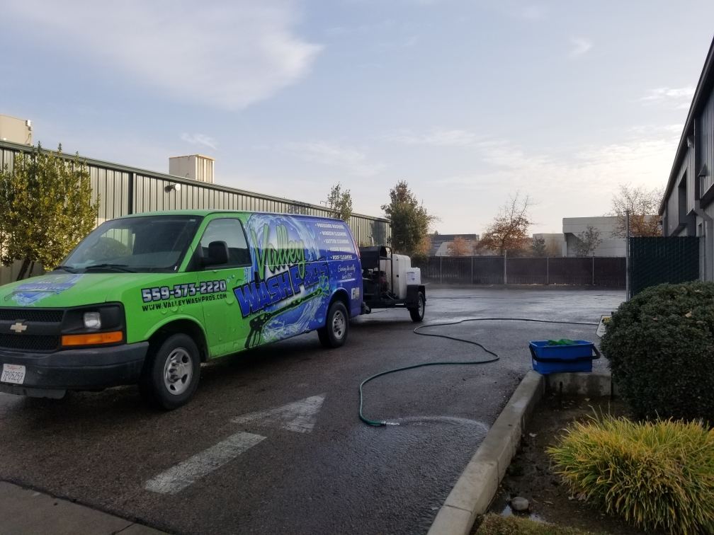 Valley Wash Pros van pressure washing at a commercial building