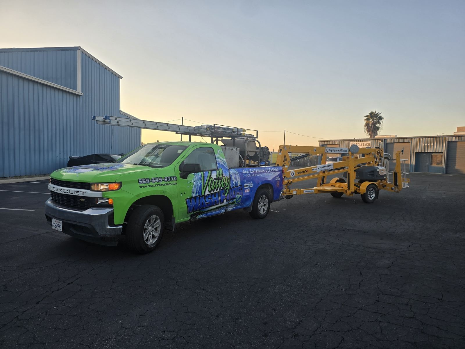 Valley Wash Pros truck and boom lift staged for a high commercial building wash