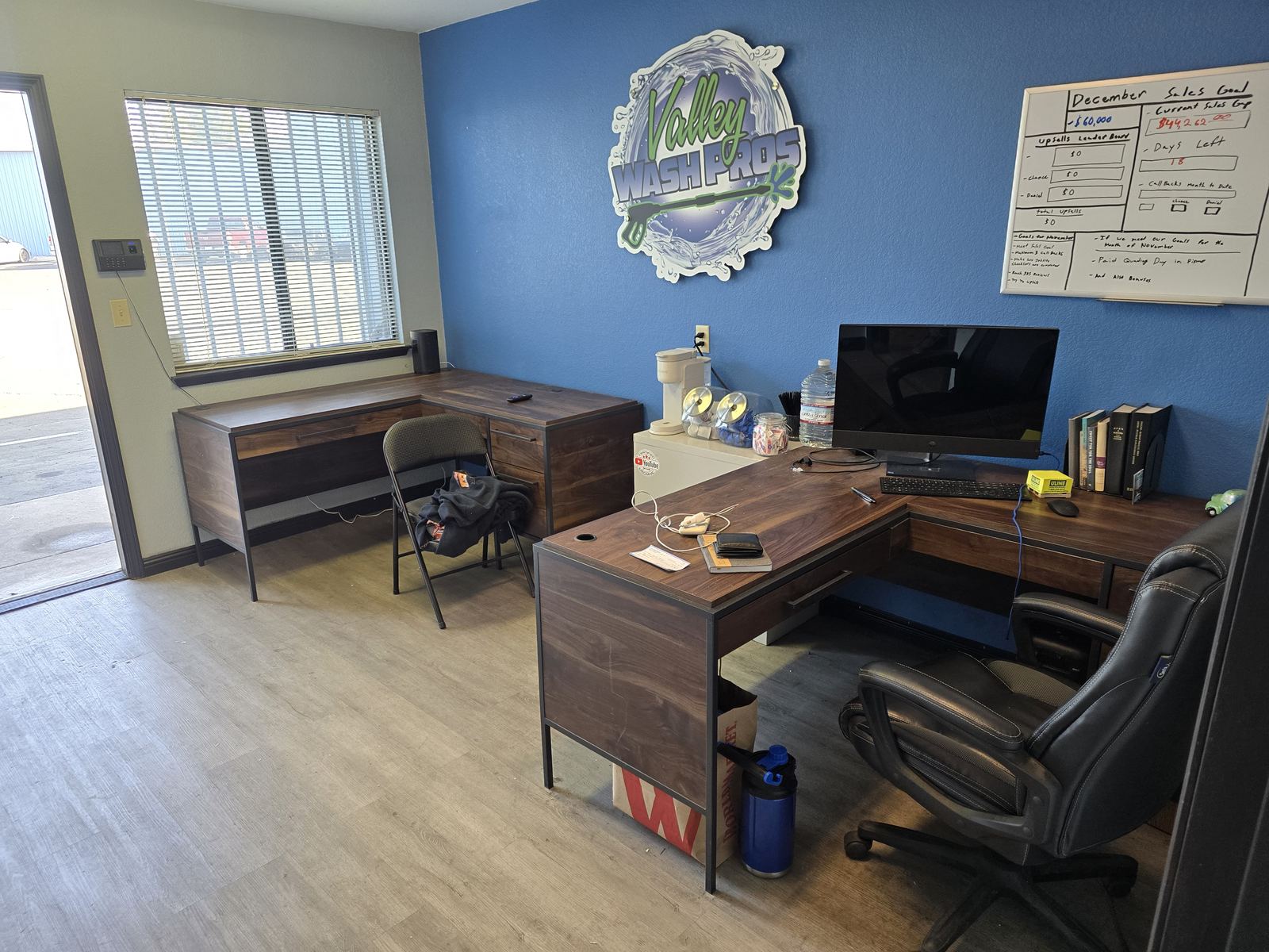 Inside the Valley Wash Pros office in Fresno with the company logo on the wall