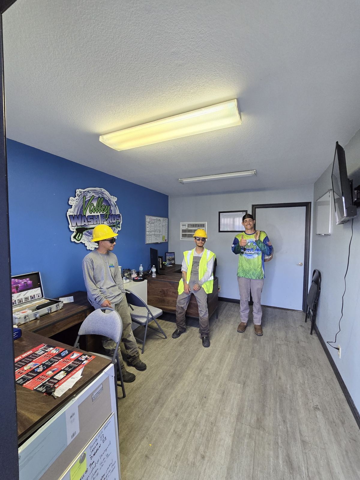 Valley Wash Pros technicians in hard hats and hi-vis vests before a commercial job