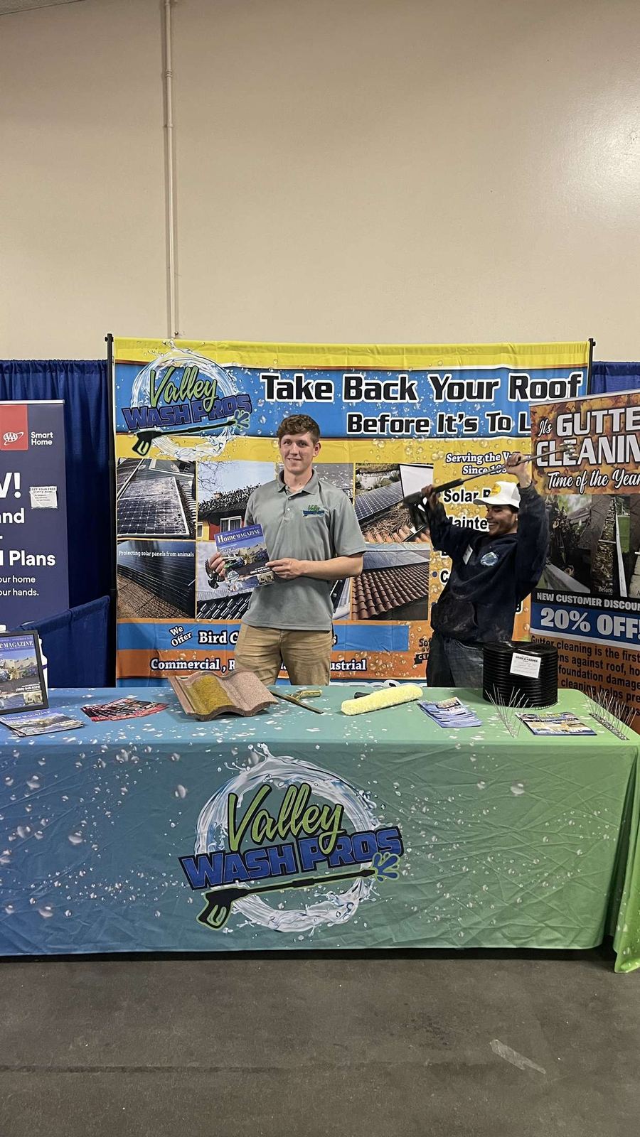 Valley Wash Pros team members at their expo booth under the services banner