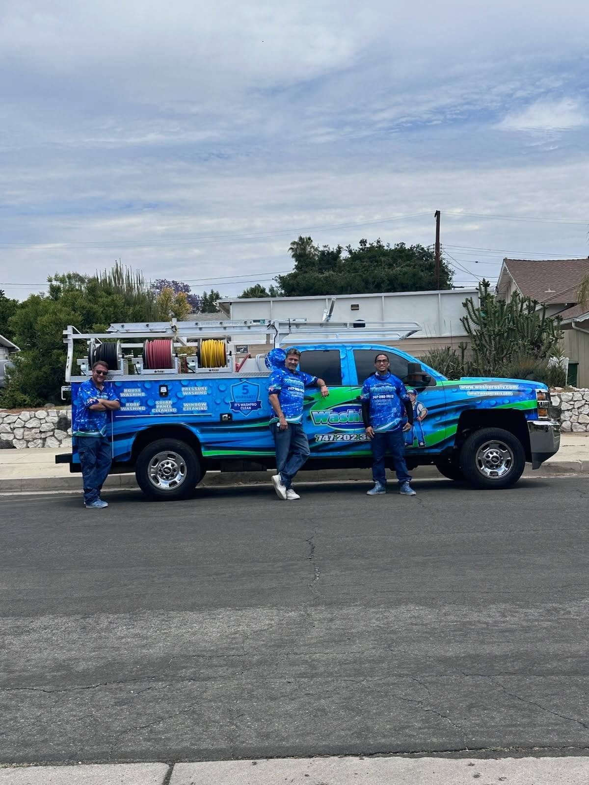 Three uniformed Valley Wash Pros technicians standing in front of the wrapped service truck