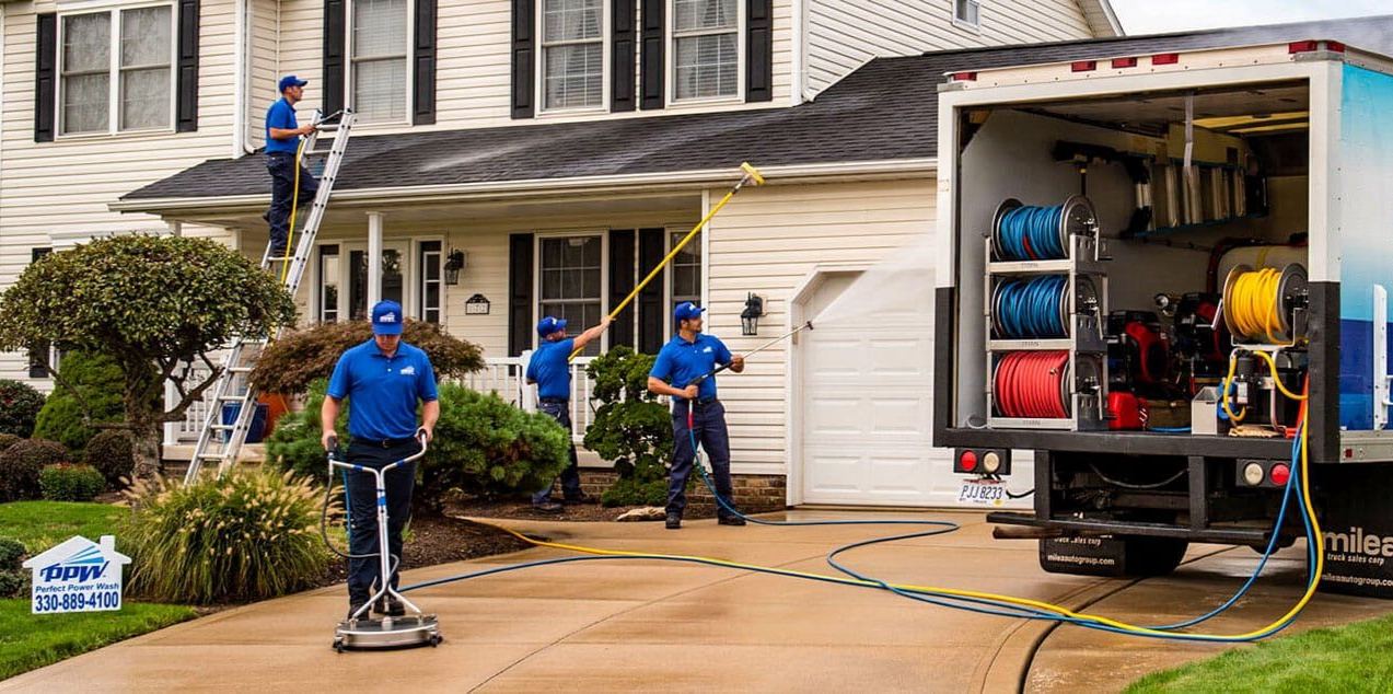 Valley Wash Pros crew soft washing a single-story home and cleaning the front walkway