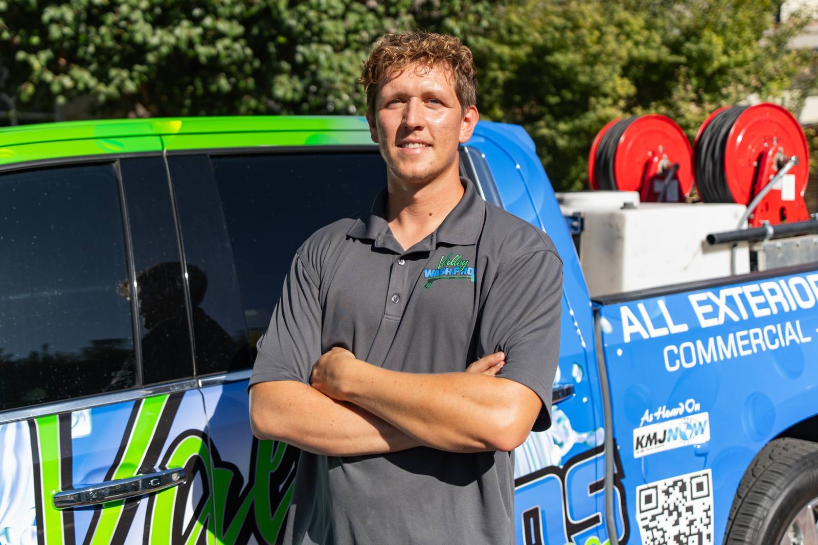 Portrait of the Valley Wash Pros owner standing in front of the wrapped service van
