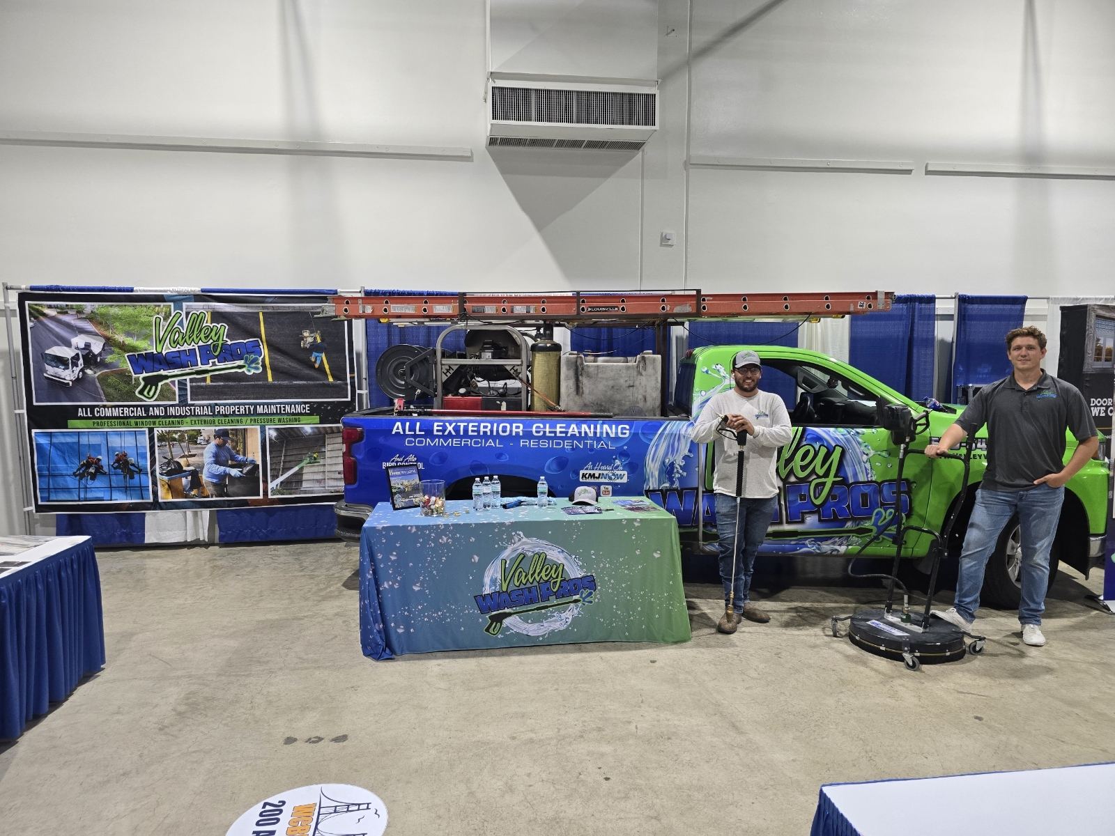 Valley Wash Pros expo booth with banner display and the company truck