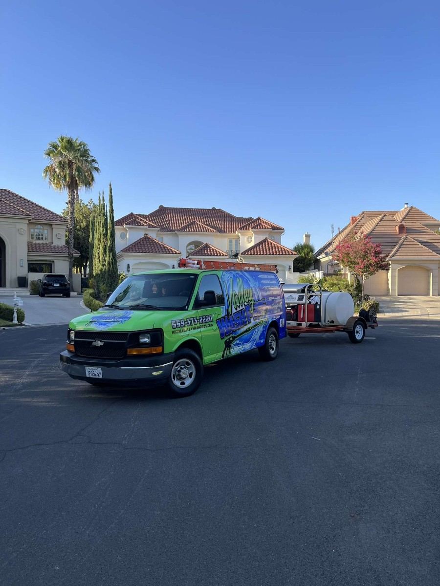 Valley Wash Pros van towing the water tank trailer that lets the crew wash fleets on site without using your yard water