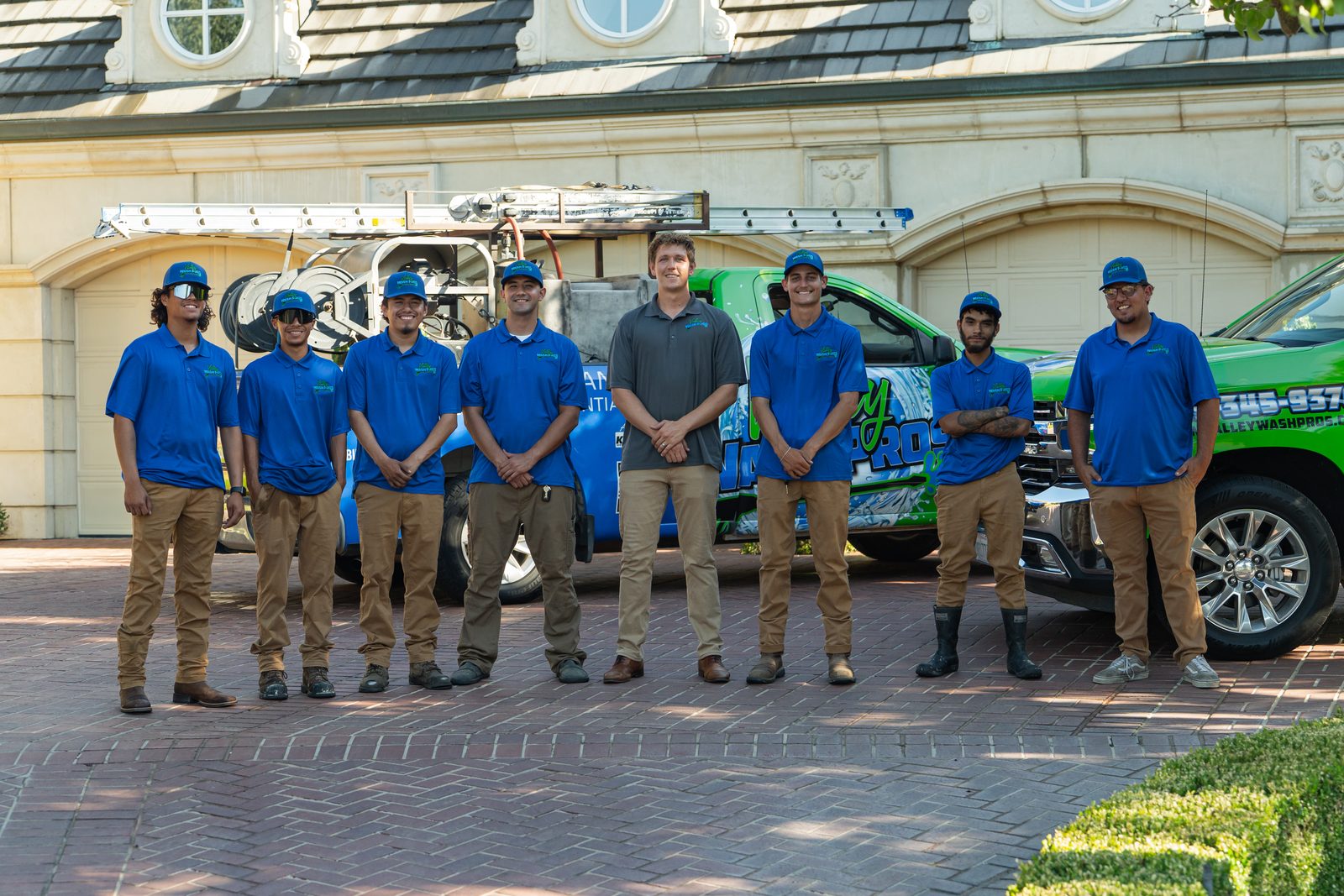 The Valley Wash Pros crew in uniform in front of their branded service truck at a Fresno home