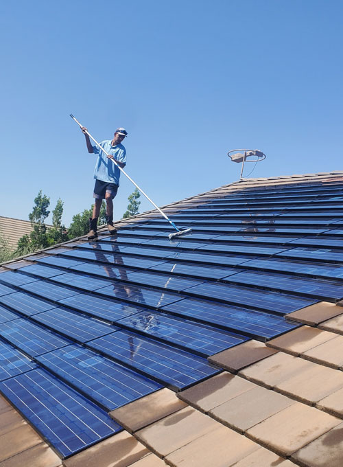 professional cleaning solar panels on home